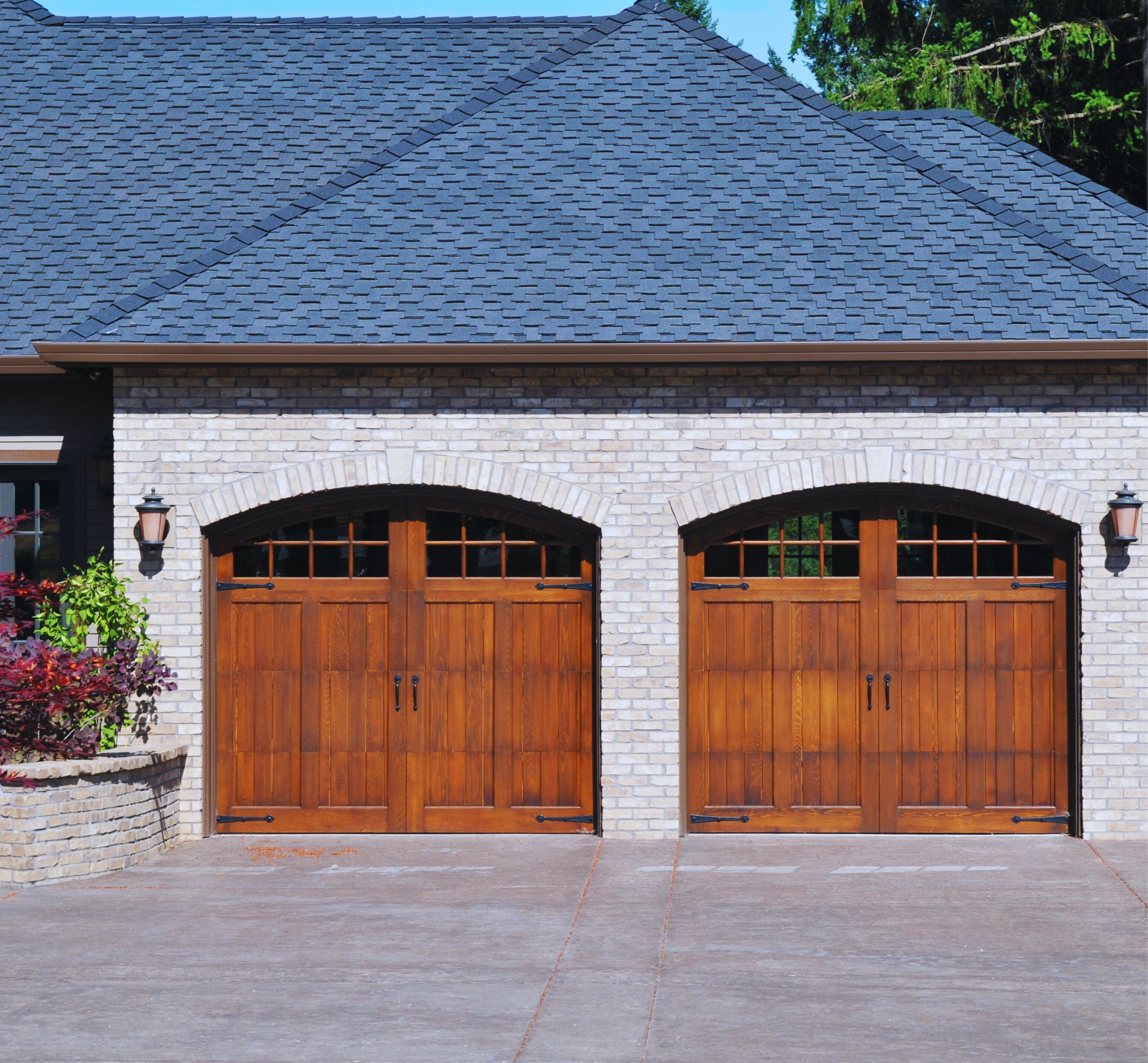 A wooden garage door of a residential property with space for two cars, showcasing the aesthetic appeal and functionality of Garage Door In My Area's installations.